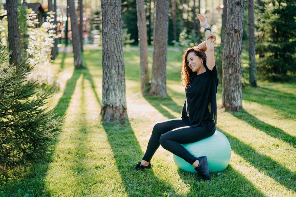 weight-loss-program-woman-sits-on-fitness-ball